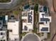 Aerial view of contemporary homes with solar panels, pools, outdoor seating areas, and lush landscaping at 12 Desert Lake Ln, Henderson, NV 89011