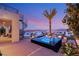 Relaxing backyard features a hot tub, outdoor seating, spiral staircase, and stunning city views at 12 Desert Lake Ln, Henderson, NV 89011