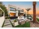 Relaxing backyard featuring a pool, spa, fire pit with seating and a spiral staircase at 12 Desert Lake Ln, Henderson, NV 89011