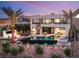 Contemporary home featuring a pool, hot tub, fire pit, and spiral staircase to a balcony at 12 Desert Lake Ln, Henderson, NV 89011
