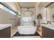 Modern bathroom featuring a soaking tub, walk-in shower, double vanity, and sleek finishes at 12 Desert Lake Ln, Henderson, NV 89011