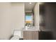 Modern bathroom featuring a floating vanity, sleek fixtures, and a large window with a scenic outdoor view at 12 Desert Lake Ln, Henderson, NV 89011