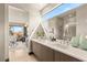 Modern bathroom with double vanity, large mirror, and walk-in shower with natural lighting at 12 Desert Lake Ln, Henderson, NV 89011