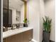Contemporary bathroom with a marble countertop vanity, modern fixtures, and decorative accents at 12 Desert Lake Ln, Henderson, NV 89011