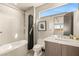 Modern bathroom boasts sleek tiled walls, a deep tub, and a floating vanity with a large mirror at 12 Desert Lake Ln, Henderson, NV 89011