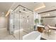 Modern bathroom with a luxurious glass shower and soaking tub, complimented by stylish fixtures and lighting at 12 Desert Lake Ln, Henderson, NV 89011