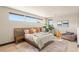 Bright bedroom features neutral walls, wood floors, area rug, and accent chair at 12 Desert Lake Ln, Henderson, NV 89011