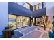 Inviting modern courtyard with custom stonework, desert plants, and an open view to the interior at 12 Desert Lake Ln, Henderson, NV 89011