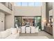 Elegant dining room with high ceilings, a modern table setting, and views into the front courtyard at 12 Desert Lake Ln, Henderson, NV 89011