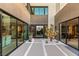 Modern home entrance featuring desert landscaping with a glass front door and large windows at 12 Desert Lake Ln, Henderson, NV 89011