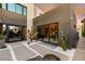 Elegant modern home entrance with unique desert landscaping, a wreath, and plenty of natural light at 12 Desert Lake Ln, Henderson, NV 89011