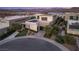 Modern home featuring clean lines, a desert landscape, and a spacious driveway with solar panels at 12 Desert Lake Ln, Henderson, NV 89011