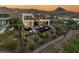 Modern two-story home with a pool, hot tub, fire pit, spiral staircase, and mountain views at sunset at 12 Desert Lake Ln, Henderson, NV 89011