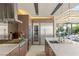 Gourmet kitchen with stainless steel appliances, wine fridge, and island featuring barstool seating at 12 Desert Lake Ln, Henderson, NV 89011