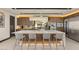 Modern kitchen with large island, breakfast bar seating, custom cabinets, and stainless steel appliances at 12 Desert Lake Ln, Henderson, NV 89011