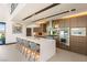 Spacious open kitchen with large island, bar seating, stainless appliances, and modern lighting at 12 Desert Lake Ln, Henderson, NV 89011
