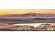 Beautiful sunset view with mountain landscape, and homes in the distance at 12 Desert Lake Ln, Henderson, NV 89011