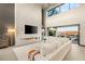 Bright living room with a modern fireplace, comfortable white sofa, and an open floor plan at 12 Desert Lake Ln, Henderson, NV 89011