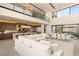 Open-concept living space with a modern kitchen, dining area, and stylish white furnishings, showcasing a sleek design at 12 Desert Lake Ln, Henderson, NV 89011