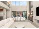 Bright, open living space with modern furnishings, a fireplace, and a dining area with a sliding door at 12 Desert Lake Ln, Henderson, NV 89011