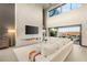 Inviting living room with a modern fireplace, a large television, and comfortable white sectional sofa at 12 Desert Lake Ln, Henderson, NV 89011