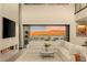 Bright, open living room featuring a fireplace, comfortable white sofa and seamless indoor/outdoor living at 12 Desert Lake Ln, Henderson, NV 89011