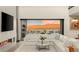 Cozy living room with a modern fireplace, a large sectional sofa, and stunning views of the mountains at 12 Desert Lake Ln, Henderson, NV 89011