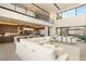 Open-concept living space with a chef's kitchen, dining area, and plush seating, offering a bright and airy atmosphere at 12 Desert Lake Ln, Henderson, NV 89011