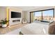 Bright main bedroom featuring a modern fireplace, flat screen television and sliding glass doors to the outdoors at 12 Desert Lake Ln, Henderson, NV 89011