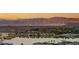 Breathtaking view of a modern neighborhood with mature landscaping and a serene lake at 12 Desert Lake Ln, Henderson, NV 89011