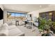 Home office with a lake view has ample natural light, neutral walls, and modern furnishings at 12 Desert Lake Ln, Henderson, NV 89011