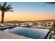 Enjoy this relaxing backyard and stunning views from the infinity pool and patio seating area at 12 Desert Lake Ln, Henderson, NV 89011