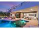 Beautiful outdoor pool and patio with modern furniture and spiral staircase, seamlessly blending indoor/outdoor living at 12 Desert Lake Ln, Henderson, NV 89011