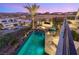 Beautiful outdoor pool and patio area with a fire pit, spa, and modern dining set at 12 Desert Lake Ln, Henderson, NV 89011