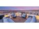 Relaxing roof deck with comfortable outdoor furniture, offering stunning city and mountain views at 12 Desert Lake Ln, Henderson, NV 89011