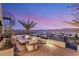 Chic roof deck featuring comfortable seating, a sleek spiral staircase, and panoramic city views at 12 Desert Lake Ln, Henderson, NV 89011