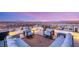 This modern rooftop deck features comfortable seating and stunning panoramic views, perfect for outdoor relaxation at 12 Desert Lake Ln, Henderson, NV 89011