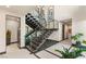 Modern staircase with metal railings, natural light, stone accents, and open design at 12 Desert Lake Ln, Henderson, NV 89011