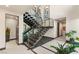 Modern staircase with metal railings, stone accents, and natural light from windows at 12 Desert Lake Ln, Henderson, NV 89011