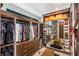 Custom walk-in closet with ample storage, shelving, drawers, and mirrored accents with modern lighting at 12 Desert Lake Ln, Henderson, NV 89011