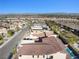 Expansive aerial view of a neighborhood with tile roofs and a glimpse of the city skyline at 12039 Rockview Point St, Las Vegas, NV 89138