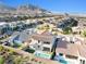 Aerial view of a two-story home with a pool, adjacent to a green lawn and garden area at 12039 Rockview Point St, Las Vegas, NV 89138