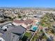 Aerial shot showcasing a backyard with a pool, lush greenery, and a neatly manicured lawn at 12039 Rockview Point St, Las Vegas, NV 89138