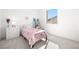Bright bedroom with pastel decor, a comfy bed, and plenty of natural light at 12039 Rockview Point St, Las Vegas, NV 89138