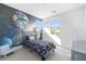 Themed bedroom with colorful space wallpaper and cozy furnishings at 12039 Rockview Point St, Las Vegas, NV 89138