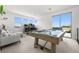 Bright game room featuring a pool table, arcade games, and a comfortable seating area at 12039 Rockview Point St, Las Vegas, NV 89138