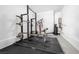 Bright home gym featuring Rogue weight rack, bench, and cable machine for complete fitness at 12039 Rockview Point St, Las Vegas, NV 89138