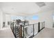 Bright hallway with open railing, modern lighting and views of the gameroom beyond at 12039 Rockview Point St, Las Vegas, NV 89138