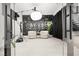 Stylish home office behind glass doors with black accent wall and modern furnishings at 12039 Rockview Point St, Las Vegas, NV 89138