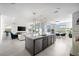 Open-concept kitchen with modern countertops, island seating, and adjacent living room with a fireplace at 12039 Rockview Point St, Las Vegas, NV 89138